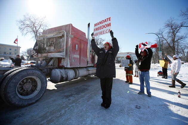 February 23, 2022, WINNIPEG, MANITOBA, CANADA: A small group of COVID-19 mandate protesters remain on the street as a convoy forms and they head home Wednesday, February 23, 2022. The group received a notice from the Winnipeg Police that they have a deadline of 5pm Wednesday to move off the street and unblock Memorial Blvd. The group plans to depart peacefully and set up a camp in a nearby park. WINNIPEG CANADA  - ZUMAc35_ 20220223_zaf_c35_063 Copyright: xJohnxWoodsx