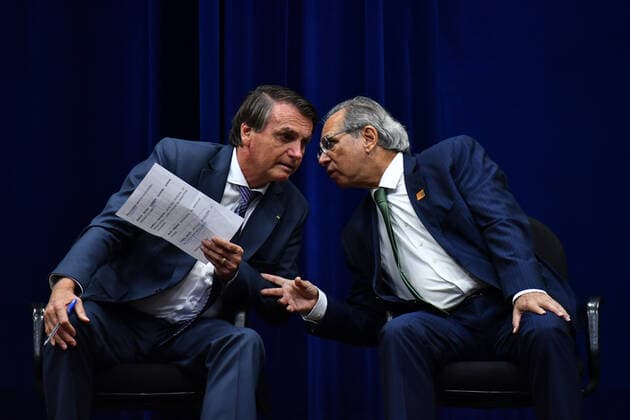 BRASÍLIA, DF - 25.02.2022: BOLSONARO MODELO REGULATÓRIO INMETRO - Photo of President Jair Bolsonaro (PL) with Paulo Guedes, Minister of Economy, during the launch ceremony of the Inmetro Regulatory Model, this Friday (25) in Brasília DF. x2174612x  AntonioxMolina