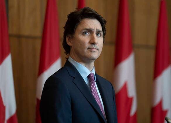 February 25, 2022, Ottawa, ON, Canada: Prime Minister Justin Trudeau watches a giant screen as Immigration, Refugees and Citizenship Minister Sean Fraser speaks via video during a news conference in Ottawa, Friday, Feb. 25, 2022. Ottawa Canada  - ZUMAc35_ 20220225_zaf_c35_051 Copyright: xAdrianxWyldx