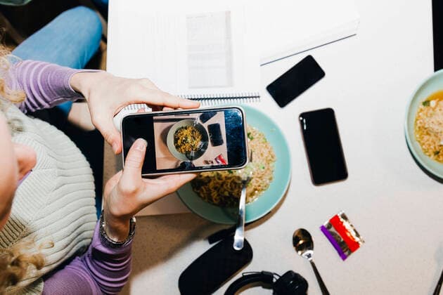 Directly above shot of young woman photographing noodles while studying in college dorm Sweden, Stockholm, model released, property released Copyright: xMaskotx , MA92277