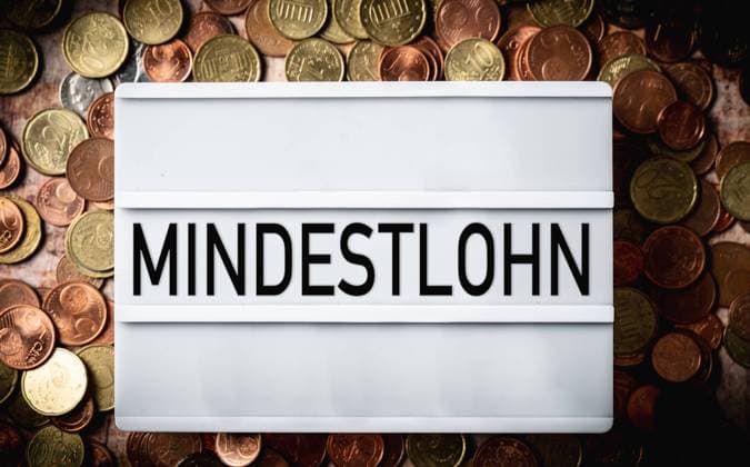 27 February 2022: minimum wage in Germany, light box with inscription minimum wage more money with euro coins FOTOMOTNAGE *** Mindestlohn in Deutschland, Licht Box mit der Aufschrift Mindest Lohn mehr Geld mit Euro Münzen FOTOMOTNAGE