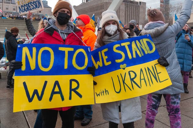 Stand With Ukraine Mega March To Support Ukraine Following Russia™s Invasion Demonstrators with yellow and blue Ukraine flags and anti-war signs in Downtown Nathan Phillips Square during a demonstration against Russian invasion in Ukraine. Toronto Ontario Canada  Copyright: xAnatoliyxCherkasovx originalFilename: cherkasov-standwit220227_npBhi.jpg