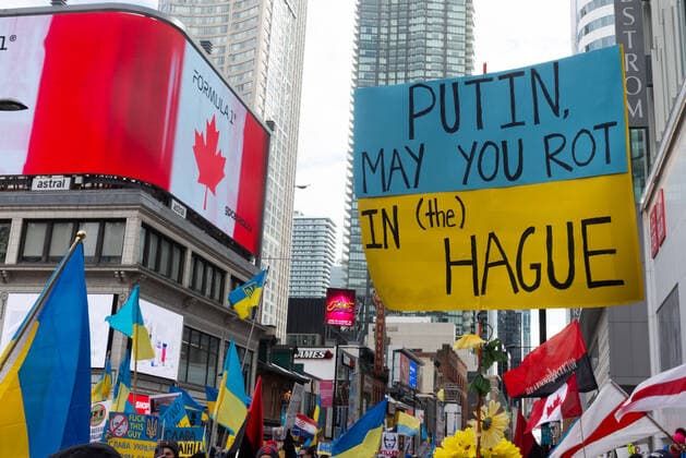 Stand With Ukraine Mega March To Support Ukraine Following Russia™s Invasion Demonstrators with yellow and blue Ukraine flags and anti-war signs in Downtown Nathan Phillips Square during a demonstration against Russian invasion in Ukraine. Toronto Ontario Canada  Copyright: xAnatoliyxCherkasovx originalFilename: cherkasov-standwit220227_npIUu.jpg