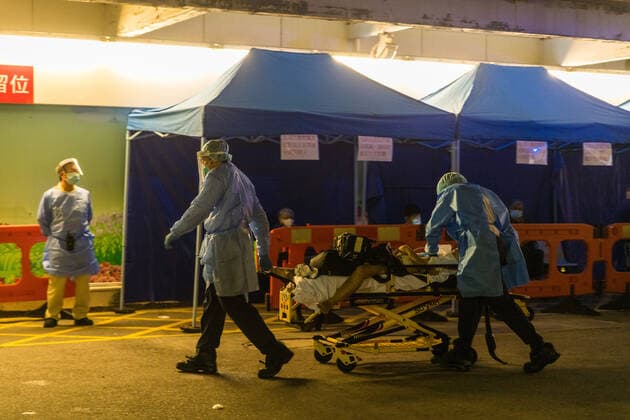 Hong Kong Hospitals Can t Keep Up With The Deaths Amid An Omicron Surge Paramedics in PPE perform CPR on a patient in cardiac arrest at the Accident & Emergency ward of Queen Elisabeth Hospital, transporting him the the ward. In the background, COVID patients are seated, awaiting to be hospitalized, in Hong Kong, China, on March 04, 2022. Hong Kong China  Copyright: xMarcxFernandesx originalFilename: fernandes-omicrons220304_npr8V.jpg