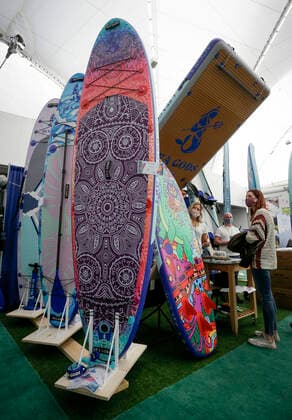 (220305) -- VANCOUVER, March 5, 2022 -- Inflatable paddleboards are displayed at the Vancouver Outdoor Adventure and Travel Show in Vancouver, British Columbia, Canada, on March 5, 2022. The two-day event, which runs on March 5th and 6th, features the latest outdoor gear and information of adventure travel ideas. (Photo by Xinhua) CANADA-VANCOUVER-OUTDOOR ADVENTURE AND TRAVEL SHOW LiangxSen 