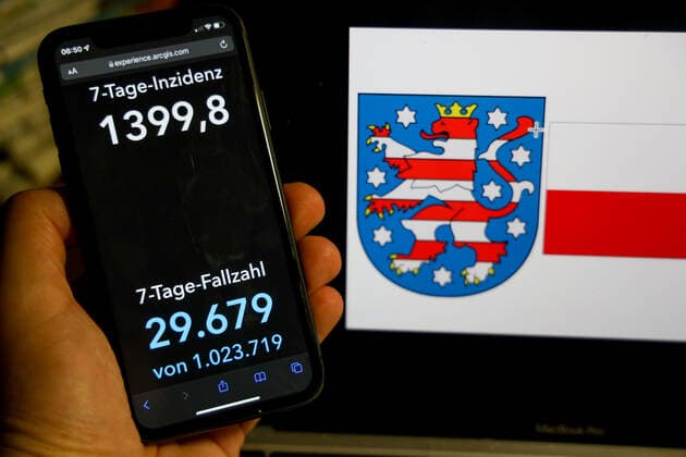 Coronavirus in Germany Covid 19 Dashboard of Robert Koch Institute DEU, Germany, Thuringia 06 03 2022 The 7 day incidence for the state Cases last 7 days 100 000 P.E. is displayed on an iPhone, with the state coat of arms in the background.