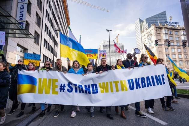 March 6, 2022, Brussels, Belgium: Demonstrator march behind a Stand with Ukraine banner during the demonstration..Thousands of people joined the demonstration in solidarity with Ukraine in the capital of Belgium. They demand the Russian to stop the invasion of Ukraine and the western nations to set up a no fly zone over Ukrainian airspaces. Brussels Belgium - ZUMAs197 20220306_zaa_s197_046 Copyright: xGeovienxSox
