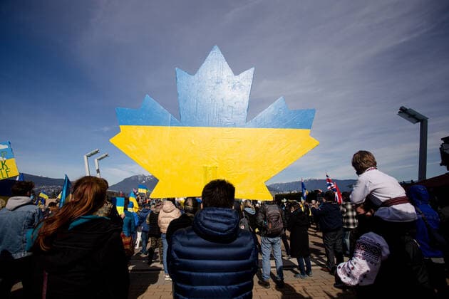 March 6, 2022, Vancouver, British Columbia, Canada: A maple leaf in Ukrainian coolers appears in the large crowd gathered at Jack Poole Plaza in Vancouver, BC to show support for Ukraine against the invasion by Russia. Vancouver Canada - ZUMA Pho 20220306_mda_w171_554 Copyright: xRyanxWalterxWagnerx
