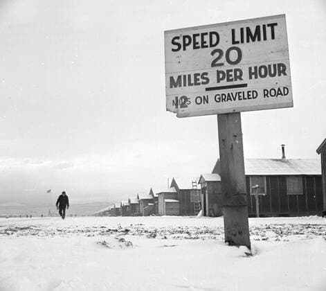 1 29 1943 - Tule Lake Relocation Center, Newell, California. View of barracks looking east down the main fire break. _ _ 1062_05_l_-7456-