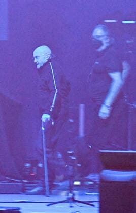 10 03 22, Hannover, Genesis Phil Collins enters the stage very sick and weakened in the dark with walking stick ZAG Arena in Hannover on the Expo area