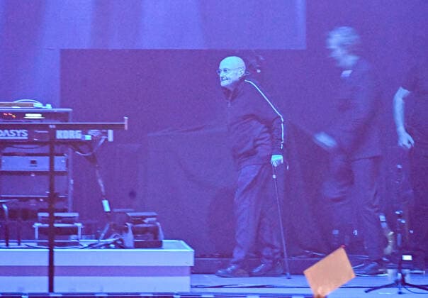 10 03 22, Hannover, Genesis Phil Collins enters the stage very sick and weakened in the dark with walking stick ZAG Arena in Hannover on the Expo area