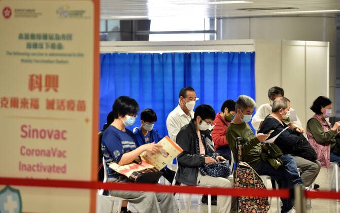 (220312) -- HONG KONG, March 12, 2022 -- People wearing masks wait to receive a dose of the COVID-19 vaccine in Tsing Yi, south China s Hong Kong, March 12, 2022. ) CHINA-HONG KONG-COVID-19 (CN) LoxPingxFai 