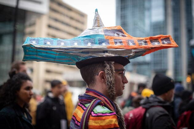 March 12, 2022, VANCOUVER, BC, CANADA: A person wears a paper model of a Seabus vessel while attending a climate action rally organized by the group 350 Canada, in Vancouver, B.C., Saturday, March 12, 2022. VANCOUVER CANADA  - ZUMAc35_ 20220312_zaf_c35_016 Copyright: xDarrylxDyckx