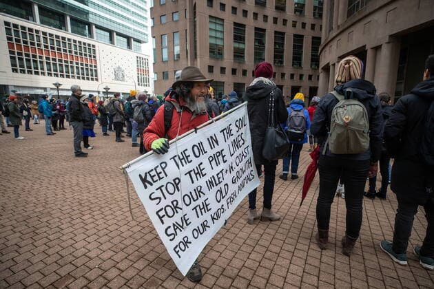 March 12, 2022, VANCOUVER, BC, CANADA: A person carries a sign while attending a climate action rally organized by the group 350 Canada, in Vancouver, B.C., Saturday, March 12, 2022. VANCOUVER CANADA  - ZUMAc35_ 20220312_zaf_c35_019 Copyright: xDarrylxDyckx