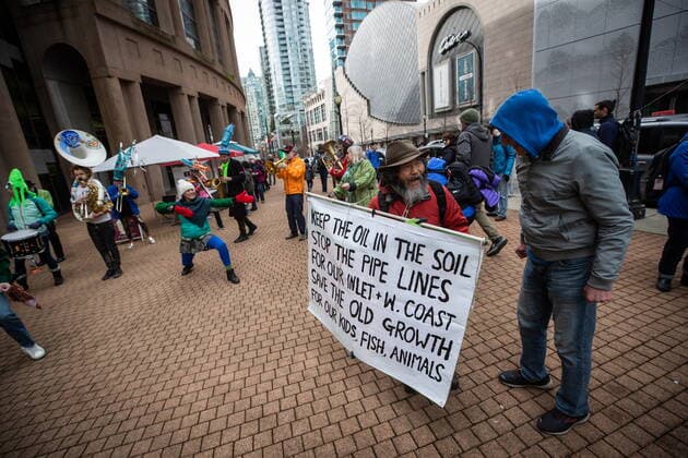 March 12, 2022, VANCOUVER, BC, CANADA: A person carries a sign while attending a climate action rally organized by the group 350 Canada, in Vancouver, B.C., Saturday, March 12, 2022. VANCOUVER CANADA  - ZUMAc35_ 20220312_zaf_c35_023 Copyright: xDarrylxDyckx