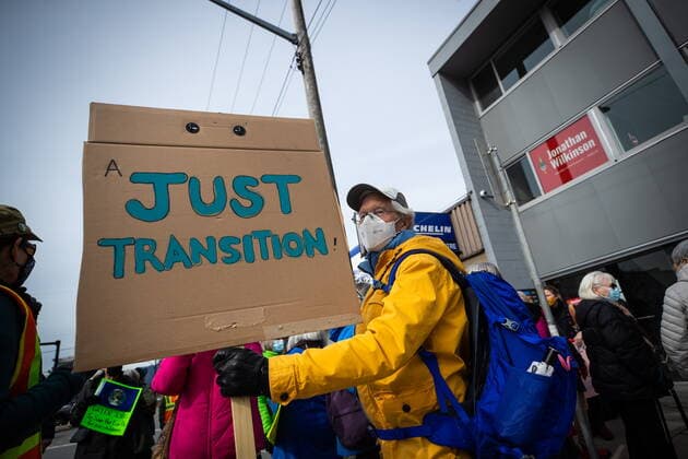 March 12, 2022, NORTH VANCOUVER, BC, CANADA: A person holds a sign while attending a climate action rally organized by the group 350 Canada outside Natural Resources Minister Jonathan Wilkinson s constituency office, in North Vancouver, B.C., Saturday, March 12, 2022. NORTH VANCOUVER CANADA  - ZUMAc35_ 20220312_zaf_c35_025 Copyright: xDarrylxDyckx