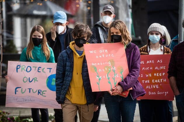 March 12, 2022, NORTH VANCOUVER, BC, CANADA: People hold signs while listening to speakers during a climate action rally organized by the group 350 Canada outside Natural Resources Minister Jonathan Wilkinson s constituency office, in North Vancouver, B.C., Saturday, March 12, 2022. NORTH VANCOUVER CANADA  - ZUMAc35_ 20220312_zaf_c35_026 Copyright: xDarrylxDyckx