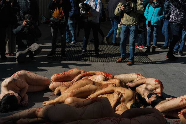 March 13, 2022, Madrid, Spain: (EDITOR s NOTE: Image contains profanity).Naked demonstrators covered in fake blood lie on Preciados street during a protest against the fur industry No Fur 2022 , in Madrid. The rally has been called as every year by the animal rights organization AnimaNaturalis to eradicate the use of animal fur in fashion and accessories. AnimalNaturalis was born to give a voice for animals that are used by humans for commercial purposes. Madrid Spain - ZUMAs197 20220313_zaa_s197_200 Copyright: xAtilanoxGarciax