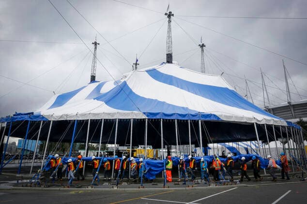 (220319) -- VANCOUVER, March 19, 2022 -- Workers are seen at the raised canvas for the Cirque du Soleil s upcoming show Alegria at Concord Pacific Place in Vancouver, British Columbia, Canada, on March 18, 2022. More than 60 workers pushed over 100 supporting poles to raise the canvas into its final position in order to set up the the iconic Big Top - where the main stage of Cirque du Soleil will take place. (Photo by Xinhua) CANADA-VANCOUVER-CIRQUE DU SOLEIL-BIG TOP-RAISING LiangxSen 