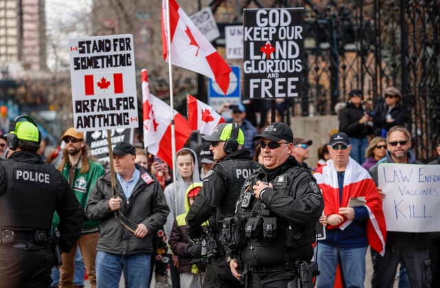 March 19, 2022, Calgary, AB, CANADA: Police officers keep watch as hundreds of demonstrators gather at city hall in Calgary, Alta., Saturday, March 19, 2022. Calgary CANADA  - ZUMAc35_ 20220319_zaf_c35_049 Copyright: xJeffxMcintoshx