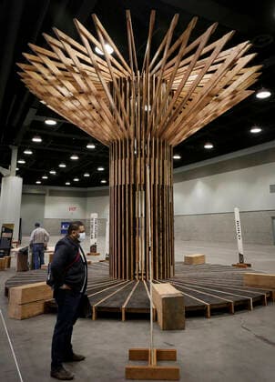 (220323) -- VANCOUVER, March 23, 2022 -- A visitor looks at a wooden construction design during the 2022 BUILDEX show in Vancouver, British Columbia, Canada, on March 23, 2022. As one of Canada s largest conferences and trade shows for building industry, the 2022 BUILDEX Vancouver kicked off on Wednesday, showcasing the latest building materials, products and technologies. (Photo by Xinhua) CANADA-VANCOUVER-2022 BUILDEX SHOW LiangxSen 