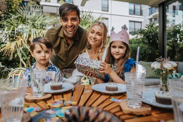 Smiling parents with children on birthday party model released property released, MFF08573