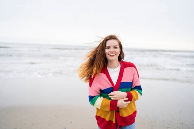 Cheerful redhead woman enjoying at beach model released, AKLF00559