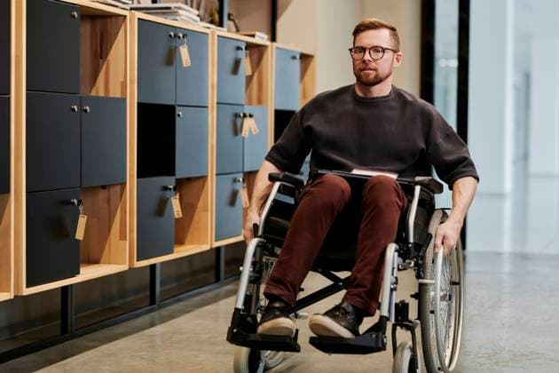 Disabled businessman sitting on wheelchair at office model released property released, DSHF00222