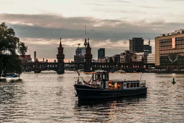 Illuminated boat on river at dusk model released property released, MJRF00644