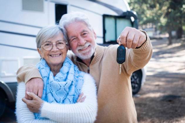 Happy senior couple with man showing motor home key model released, SIPF02788