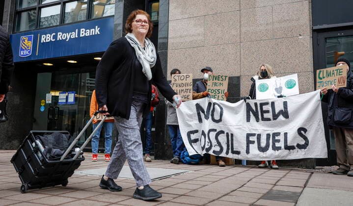 March 25, 2022, Calgary, AB, CANADA: A pedestrian walks past as climate activists demonstrate in support of Fridays for Future in downtown Calgary, Alta., Friday, March 25, 2022. Calgary CANADA  - ZUMAc35_ 20220325_zaf_c35_059 Copyright: xJeffxMcintoshx