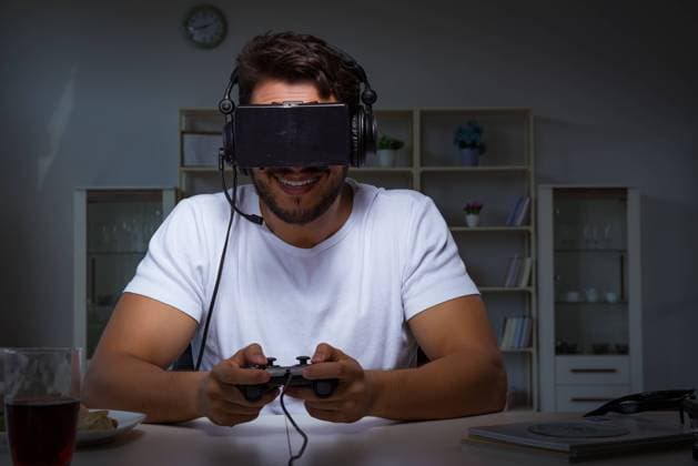 Young man playing games long hours late in the office, model released, , property released, , 33287496.jpg, home, gamer, video, technology, young, game, gaming, entertainment, fun, computer, man, leisure, play, internet, online, room, headphone, controller, playing, virtual, joystick, pc, console, digital, teenager, headset, boy, reality, electronic, control, tv, keyboard, enjoyment, competition, gamepad, nerd, gadget, couch, vr, 3d, augmented, glasses, goggles, addict, addiction, night, late, evening, employee, student,