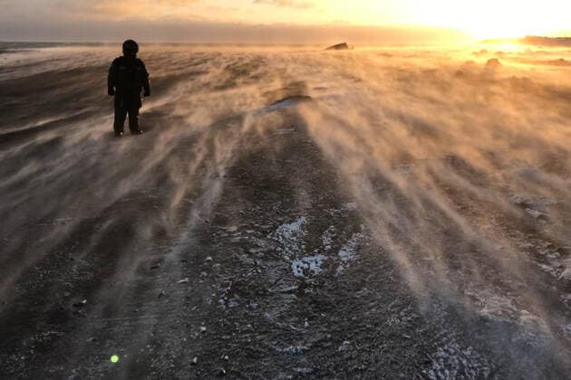 A man stands in the wind in the tundra in winter. The ground from the strong wind, the frost on the street., model released, , property released, , 33394706.jpg, winter, mountain, backpack, wind, drifting snow, blowing, alaska, chukotka, arctic, blizzard, snow, cold, harsh, fur coat, dress, blows, sunset, man, traveler, nature, white, landscape, tourism, ice, travel, tundra, outdoor, walking, blue, beautiful, copy space, nepal, snowy, view, road, fog, stormy, china, kite, india, peak, sun, sichuan, far away, polar, photo, trekking, snowy background, motorbike, tibet,
