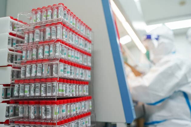 (220329) -- SHANGHAI, March 29, 2022 -- A staff member works at a COVID-19 nucleic acid testing laboratory in east China s Shanghai, March 23, 2022. The laboratory of Tongji Hospital, which has 10 testing facilities, can daily process more than 10 thousands tubes of samples for nucleic acid tests. ) Xinhua Headlines: China acts swiftly to contain COVID-19 resurgence DingxTing 