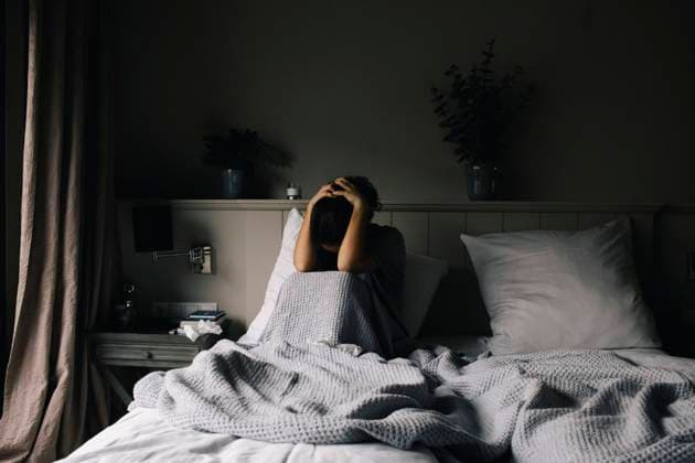 Emotionally depressed woman suffering from mental disorder sitting on bed at home Germany, Berlin, model released, property released Copyright: xMaskotx , MA92654