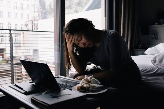 IMAGO Creative: Gesundheit, Magersucht, Bulimie Emotionally exhausted lonely woman sitting with laptop in bedroom at home Germany, Berlin, model released, property released Copyright: xMaskotx , MA92673