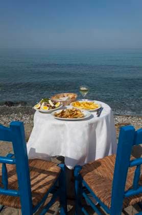 greek food outdoors and the sea , 14115490.jpg, greek, sea, healthy, salad, green, white, french, fries, potato, fresh, plate, table, oil, mediterranean, olive, summer, food, sun, raw, island, tomato, pepper, cheese, fried, zucchini, courgette, appetizer, onion, lettuce, wine, bread, ouzo, feta, ocean, greece, outdoor, sky, evening, glass, drink, rock, sand, nobody, simple, holiday, vacation, Chalkidiki, chair, tourism,