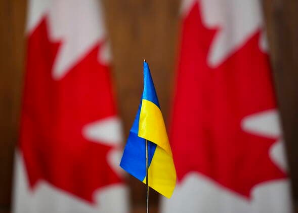 April 1, 2022, Ottawa, Ontario, Canada: A Ukrainian flag is pictured in front of Canadian flags during a press conference held by a visiting Ukrainian delegation of members of Parliament in Ottawa on Friday, April 1, 2022. Ottawa Canada  - ZUMAc35_ 20220401_zaf_c35_005 Copyright: xThexCanadianxPressx