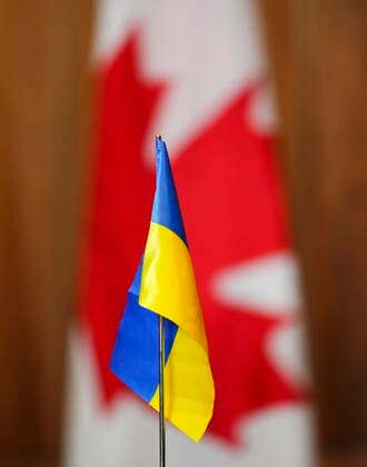 April 1, 2022, Ottawa, Ontario, Canada: A Ukrainian flag is pictured in front of Canadian flags during a press conference held by a visiting Ukrainian delegation of members of Parliament in Ottawa on Friday, April 1, 2022. Ottawa Canada  - ZUMAc35_ 20220401_zaf_c35_009 Copyright: xThexCanadianxPressx