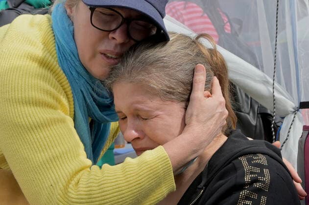 April 1, 2022, Tijuana, Baja California, Mexico: VALENTYNA, 56, from Kharkiv; one of the city epicenters of the Ukraine-Russia conflict, is overwhelmed with emotion after arriving at an impromptu camp established by more than 1,000 Ukrainian refugees waiting to get asylum to the United States at the San Ysidro, Port of Entry in Tijuana, Mexico on Friday. Tijuana Mexico - ZUMAm180 20220401_zip_m180_010 Copyright: xCarlosxA.xMorenox