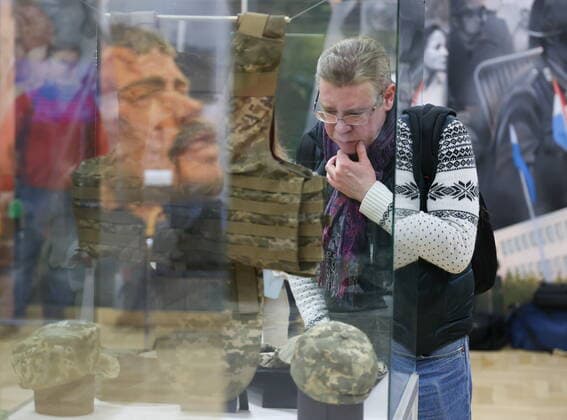 MOSCOW, RUSSIA - APRIL 4, 2022: A man views a bulletproof vest of the Armed Forces of Ukraine made according to the 2020s NATO standards, on display at the exhibition NATO: The Chronicle of Cruelty at the State Central Museum of Contemporary History of Russia. Anton Novoderezhkin TASS  TS12B014