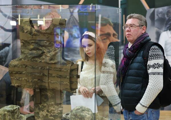 MOSCOW, RUSSIA - APRIL 4, 2022: People view a bulletproof vest of the Armed Forces of Ukraine made according to the 2020s NATO standards, on display at the exhibition NATO: The Chronicle of Cruelty at the State Central Museum of Contemporary History of Russia. Anton Novoderezhkin TASS  TS12B02C