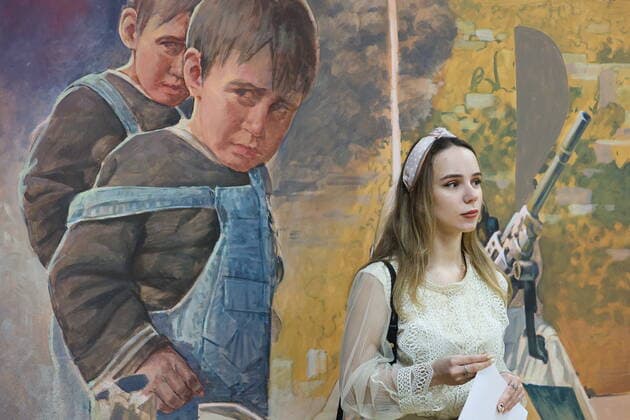 MOSCOW, RUSSIA - APRIL 4, 2022: A girl attends the exhibition NATO: The Chronicle of Cruelty at the State Central Museum of Contemporary History of Russia. Anton Novoderezhkin TASS  TS12B02D