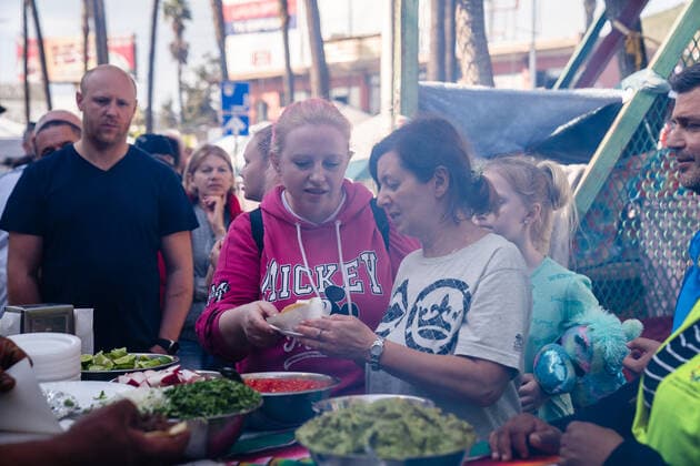 Ukrainians who fled to Mexico amid Russia s invasion of Ukraine wait in line to eat tacos prepared by Fundacion Binacional Tijuana Sin Hambre A.C., while they wait at a makeshift camp near the San Ysidro Port of Entry of the U.S.-Mexico border on Monday, April 4, 2022 in Tijuana, Mexico. The refugees are given a number so they do not have to wait in line as the United States said they will accept 100,000 Ukrainian refugees due to the Russian invasion of Ukraine.  MEX2022040422 ARIANAxDREHSLER
