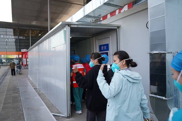 (220406) -- SHANGHAI, April 6, 2022 -- Medical workers from central China s Hubei Province enter the makeshift hospital in east China s Shanghai, April 6, 2022. The first batch of supportive medics from Hubei on Wednesday started working in the makeshift hospital in Shanghai to aid the megacity in its fight against resurging COVID-19. ) CHINA-SHANGHAI-MAKESHIFT HOSPITAL-MEDICAL TEAM FROM HUBEI (CN) YuanxQuan 