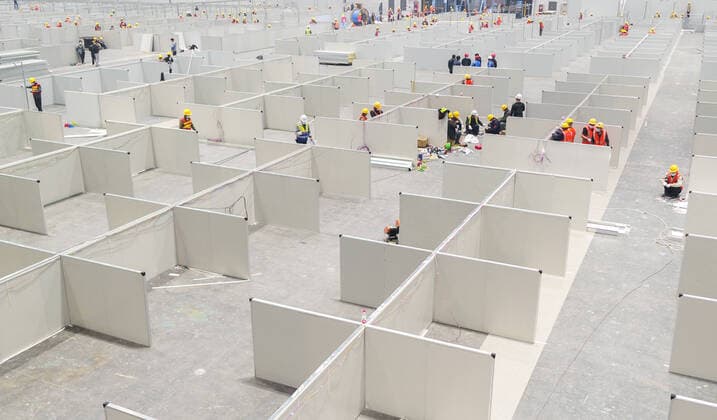 (220406) -- SHANGHAI, April 6, 2022 -- People work at the National Exhibition and Convention Center in east China s Shanghai, April 6, 2022. Shanghai is converting the National Exhibition and Convention Center (NECC) into a makeshift hospital with a planned capacity of 40,000 beds. Upon completion, it is expected to act as the biggest such hospital for those testing positive for COVID-19 in the metropolis. ) CHINA-SHANGHAI-NECC-MAKESHIFT HOSPITAL (CN) DingxTing 
