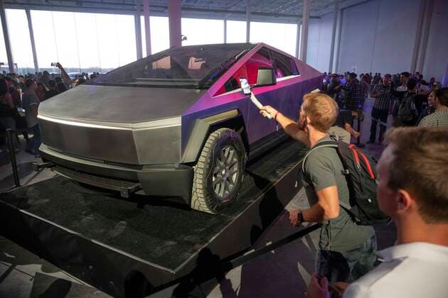 April 7, 2022, Austin, TX, United States: A man films the new Tesla Cybertruck as some of the invited 15,000 guests tour the new Tesla Gigafactory Texas near Austin during its private grand opening event on April 7, 2022. The plant is the largest manufacturing facility in the U.S. and will gear up to turn out over 1,000 electric cars per day. Austin United States - ZUMAd150 20220407_znp_d150_048 Copyright: xBobxDaemmrichx
