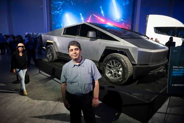 April 7, 2022, Austin, TX, United States: A man poses with the new Tesla Cybertruck as some of the invited 15,000 guests tour the new Tesla Gigafactory Texas near Austin during its private grand opening event on April 7, 2022. The plant is the largest manufacturing facility in the U.S. and will gear up to turn out over 1,000 electric cars per day. Austin United States - ZUMAd150 20220407_znp_d150_050 Copyright: xBobxDaemmrichx