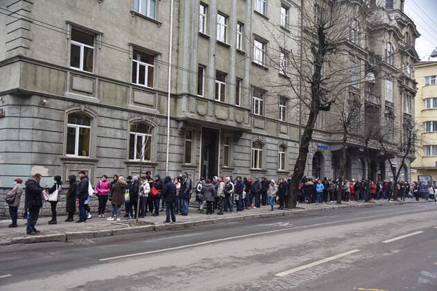March 31, 2022, Lviv, Ukraine: People stand in a line at the UN refugee office in Lviv to register as refugees due to Russia s military invasion of Ukraine. The UN Office for Refugees, which registers refugees from Russian military aggression in Ukraine, has opened in Lviv. Each refugee will receive 2,200 hryvnias (equivalent to $ 80) from the UN each month for three months. Currently, such offices operate only in three Ukrainian cities - Lviv, Uzhhorod, and Mukachevo. Lviv Ukraine - ZUMAs197 20220331_zab_s197_094 Copyright: xPavloxPalamarchukx
