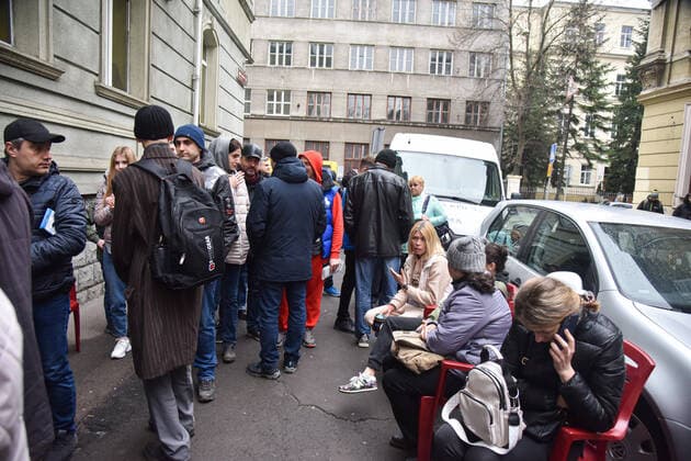 March 31, 2022, Lviv, Ukraine: People stand in a line at the UN refugee office in Lviv to register as refugees due to Russia s military invasion of Ukraine. The UN Office for Refugees, which registers refugees from Russian military aggression in Ukraine, has opened in Lviv. Each refugee will receive 2,200 hryvnias (equivalent to $ 80) from the UN each month for three months. Currently, such offices operate only in three Ukrainian cities - Lviv, Uzhhorod, and Mukachevo. Lviv Ukraine - ZUMAs197 20220331_zab_s197_095 Copyright: xPavloxPalamarchukx